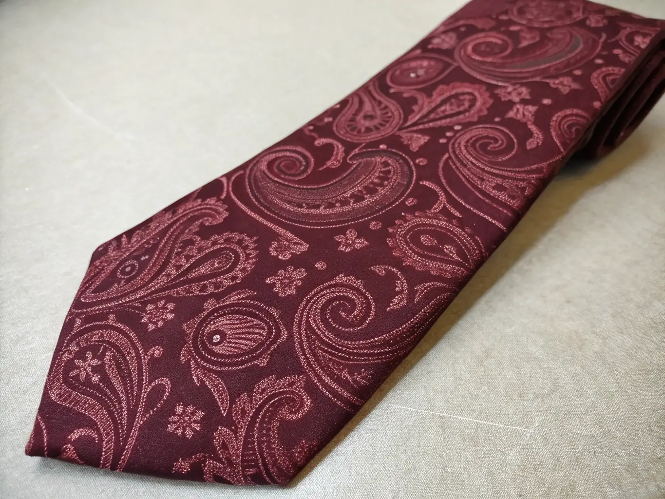 A detailed image of a selection of Casual Play Shirts neckties, featuring subtle Christian symbols and elegant patterns, arranged on a display stand.