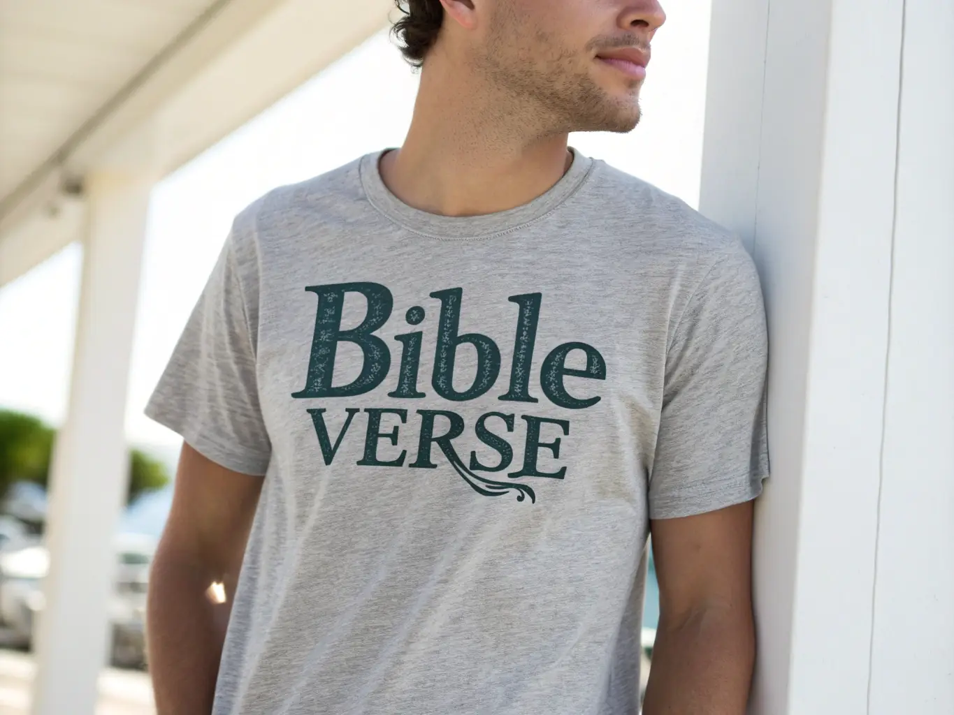 A person smiling and wearing a Casual Play Shirts t-shirt with a Bible verse printed on it, set in a casual outdoor setting.